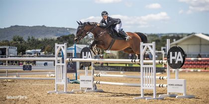 Sarah Weiss and Waratone over the Homes & Acreage jump in the Racing Victoria Off The Track Championship. © Australian Jumping